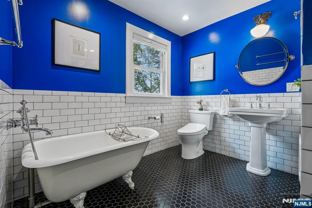 31 Nassau Road Montclair, NJ 07043 - Photo 19 of 33 a bathroom with a toilet a sink and mirror