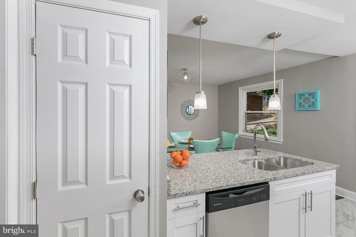 3924 Yolando Road Baltimore, MD 21218 - Photo 2 of 29 a kitchen with stainless steel appliances granite countertop a sink and dishwasher with white cabinets