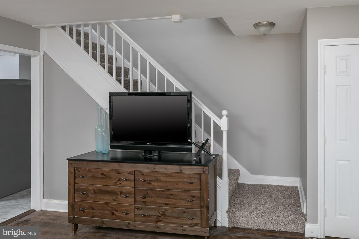 3924 Yolando Road Baltimore, MD 21218 - Photo 11 of 29 a living room with wooden floor and a flat screen tv