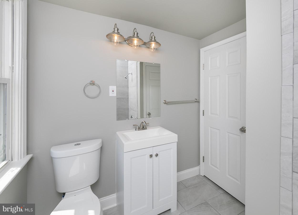3924 Yolando Road Baltimore, MD 21218 - Photo 19 of 29 a bathroom with a toilet sink and mirror