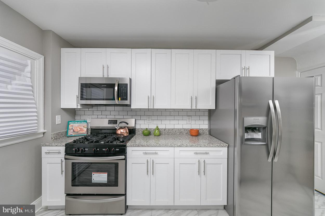 3924 Yolando Road Baltimore, MD 21218 - Photo 6 of 29 a kitchen with a refrigerator stove and microwave