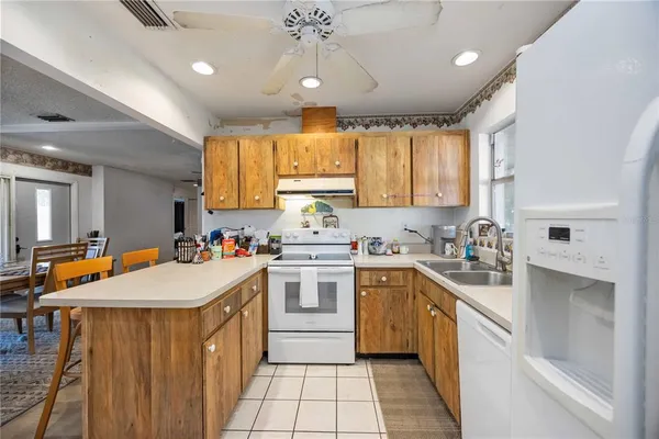 a kitchen with a sink window and cabinets