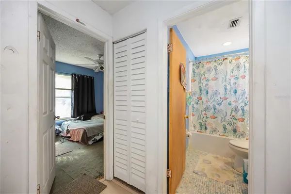 a view of a bedroom with a bed and a closet