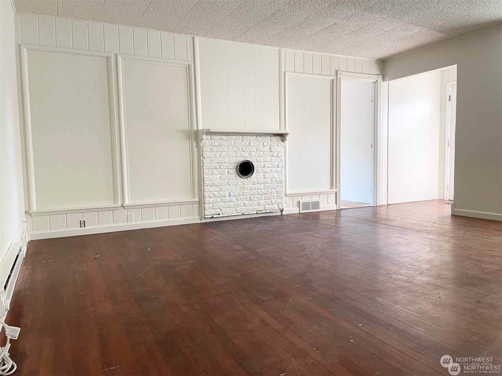 2204 Northeast 10th Place Renton, WA 98056 - Photo 3 of 6 a view of an empty room with wooden floor and a window