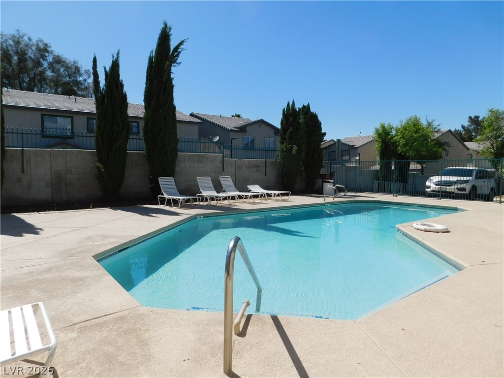 5221 South Lindell Road, Unit 202 Las Vegas, NV 89118 - Photo 3 of 28 An inviting pool area awaits under a clear sky, offering a refreshing escape.