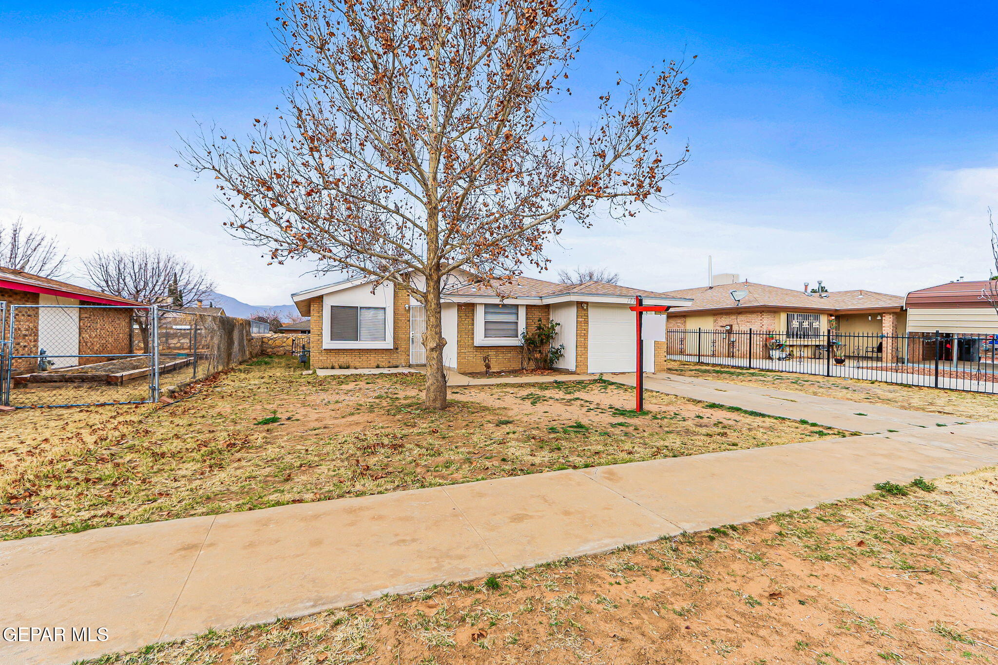 10801 Rhyolite Drive El Paso, TX 79924 - Photo 2 of 23 a front view of a house with a road