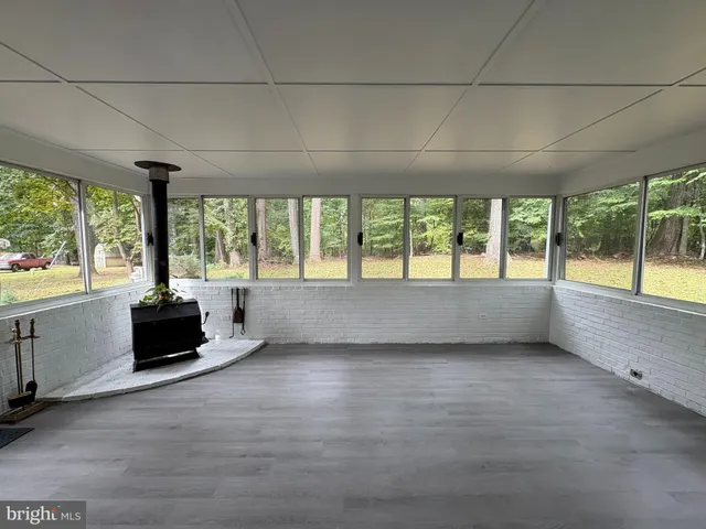 an empty room with large windows