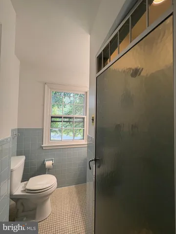 a bathroom with a toilet a sink and shower