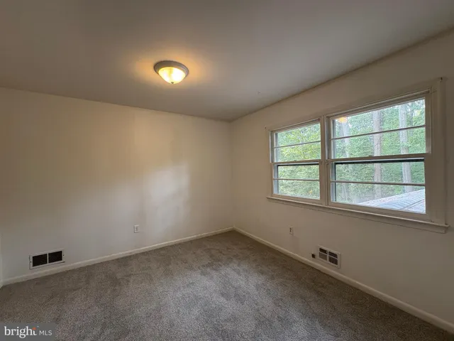 an empty room with a empty space and windows