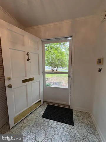 a view of a hallway to rooms