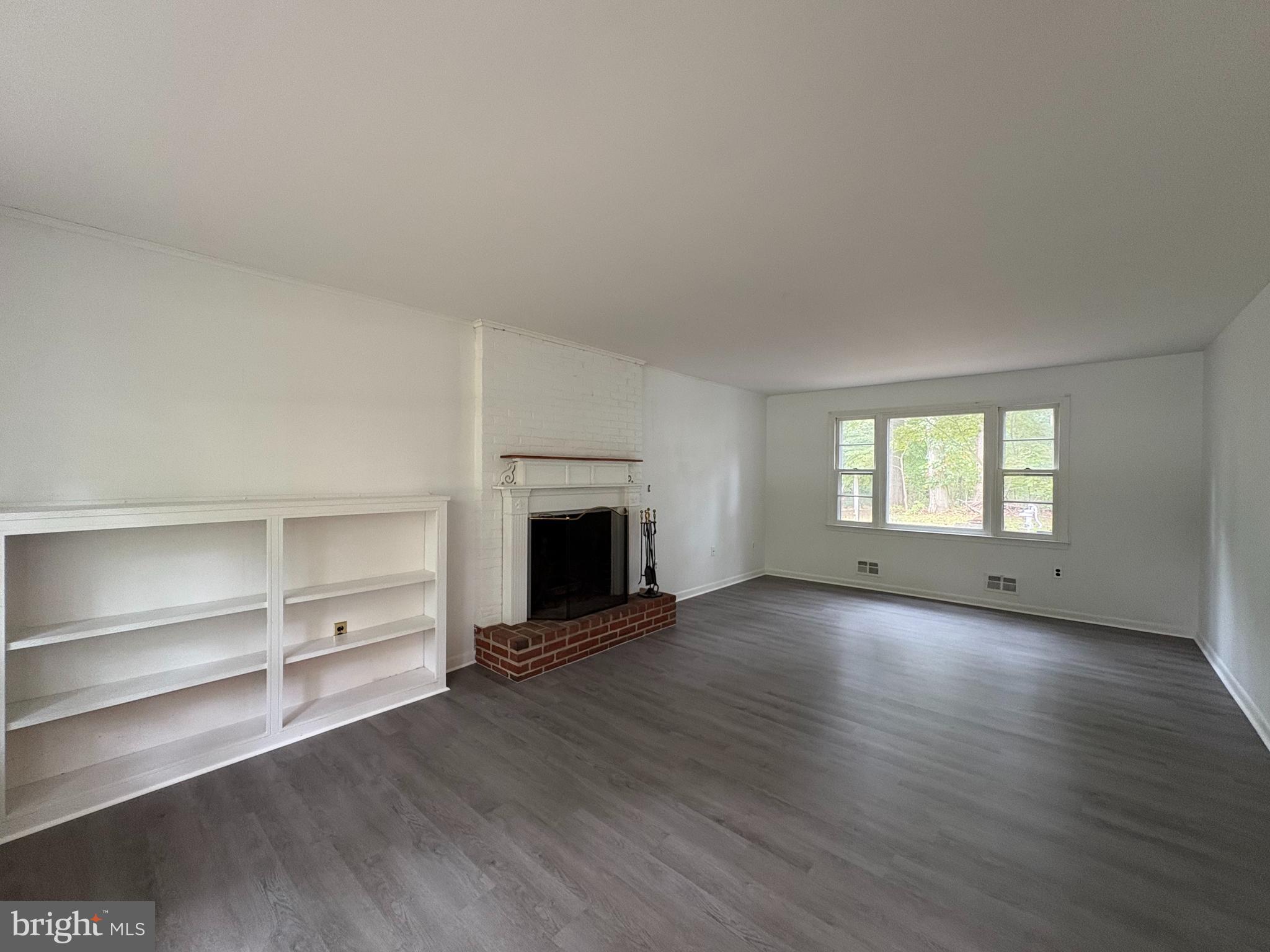 3306 Whitesworth Road Phoenix, MD 21131 - Photo 6 of 31 a view of an empty room with a fireplace and a window
