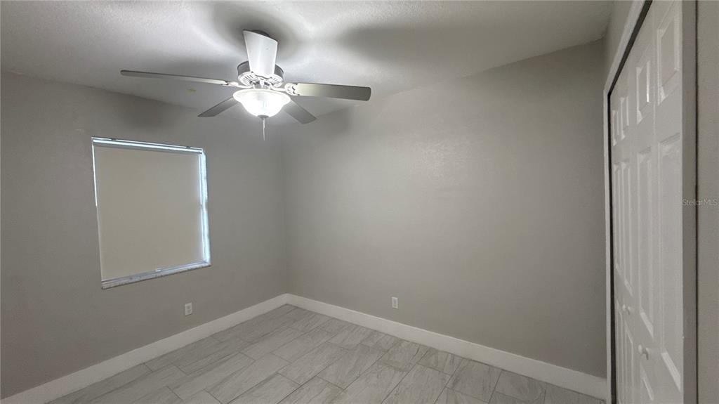 8106 Wichita Way Tampa, FL 33619 - Photo 16 of 21 en empty room with a fan and a window
