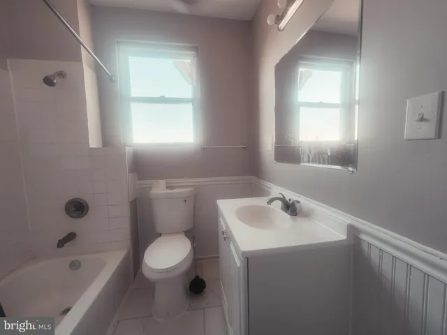 a bathroom with a sink a toilet and a bathtub