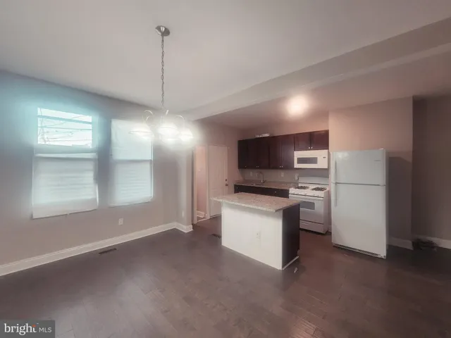 a view of kitchen with sink microwave and refrigerator