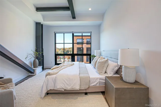 a bedroom with a bed and window