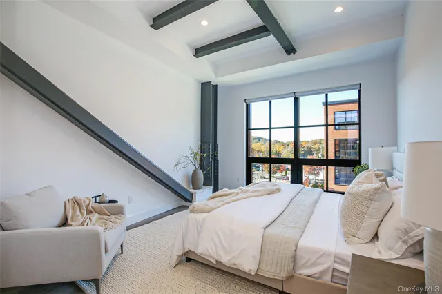 a bedroom with a bed and glass window