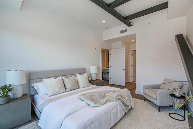 a bedroom with bed and a couch