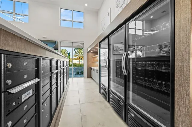 a living room with furniture a potted plant and kitchen view