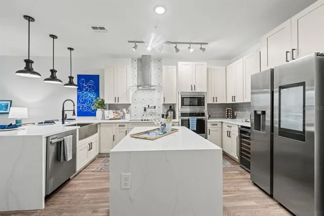 a kitchen with a sink stainless steel appliances and cabinets