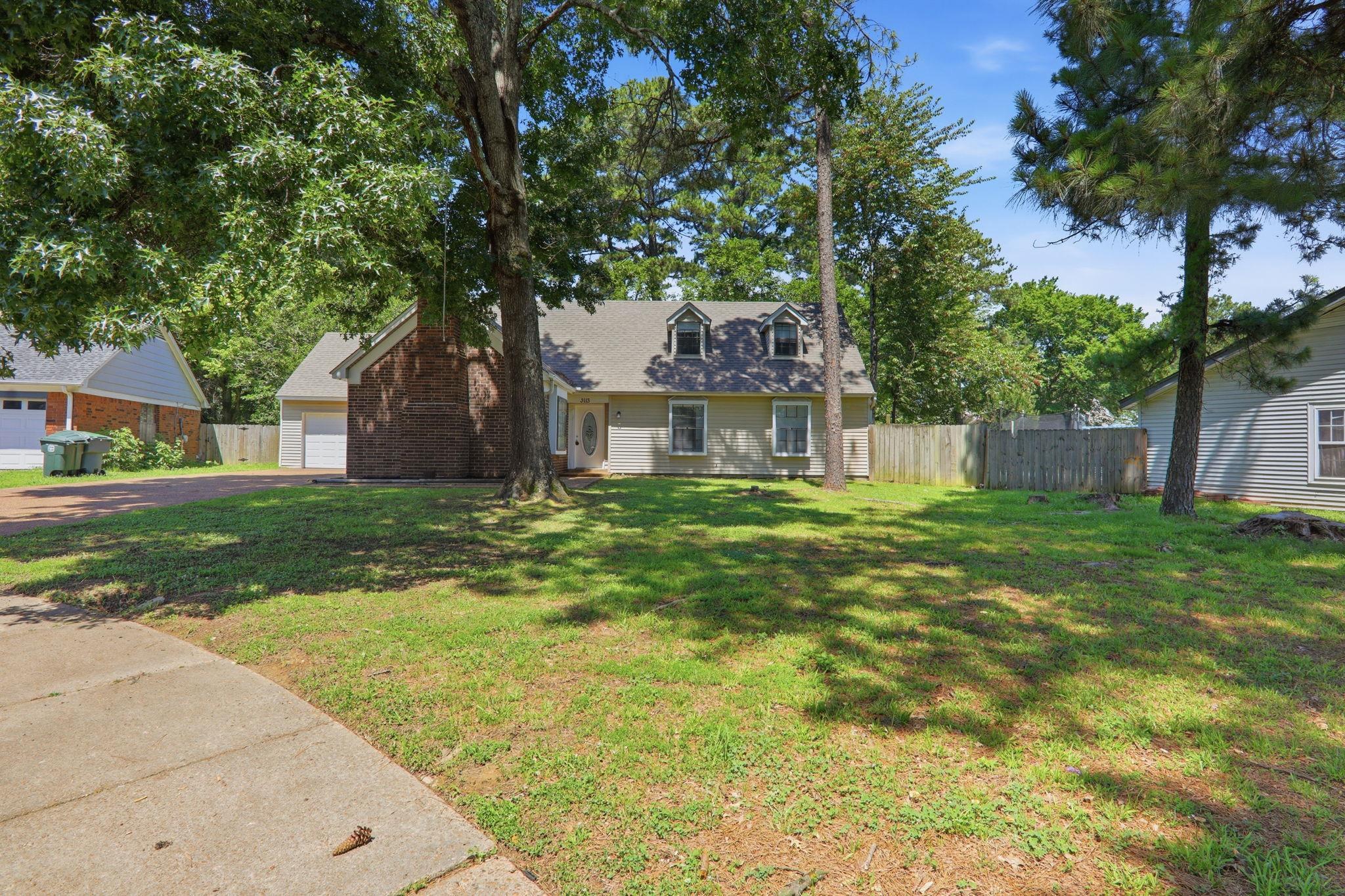 3113 Raleigh Ridge Cove Memphis, TN 38128 - Photo 1 of 38 Front exterior featuring a dormered roofline, brick chimney, and a concrete driveway leading to an attached garage