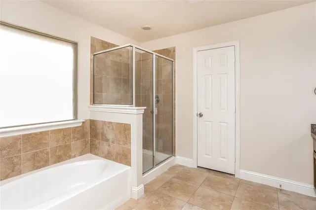 a bathroom with a bathtub and a shower