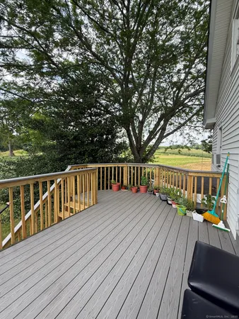 a view of balcony with wooden floor and fence
