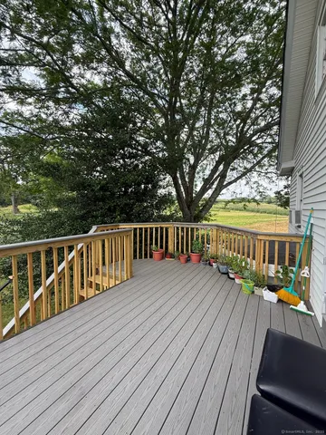 a view of balcony with wooden floor and fence