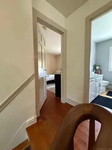 a bedroom with a bed and mirror