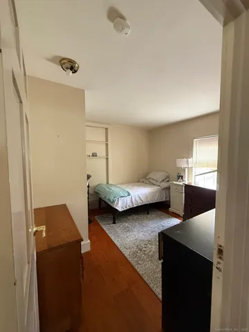 a bedroom with bed and window