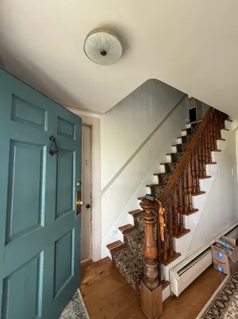 a view of entryway and hall with wooden floor