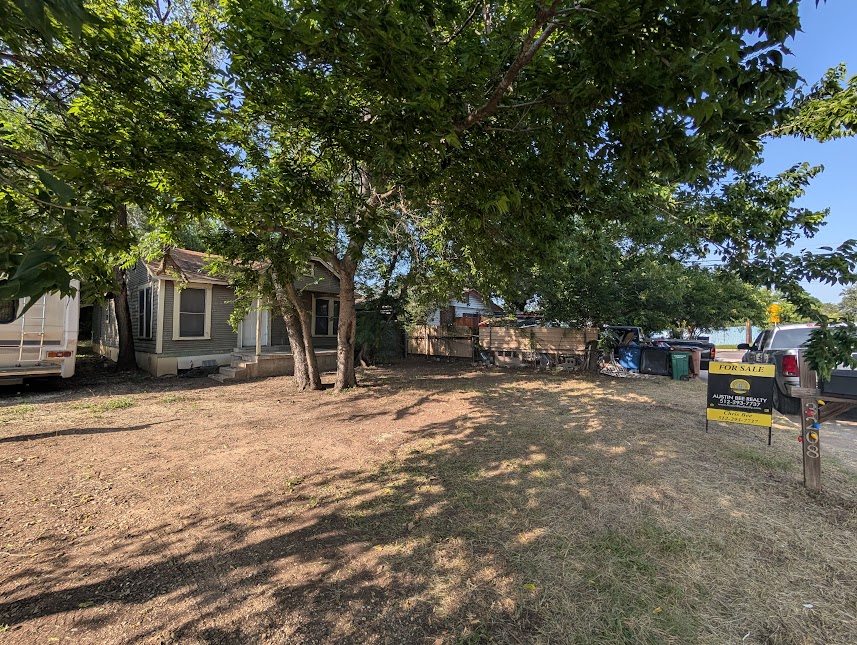 3208 East 16th Street Austin, TX 78721 - Photo 1 of 11 Mature trees shade this inviting front yard, offering a tranquil retreat.