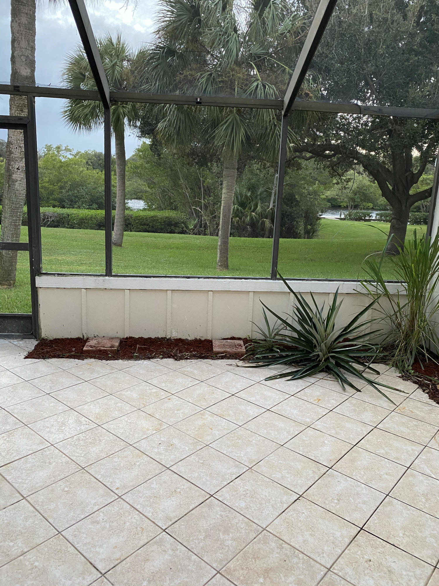 6183 Riverwalk Lane, Unit 3 Jupiter, FL 33458 - Photo 12 of 35 a view of backyard with tree