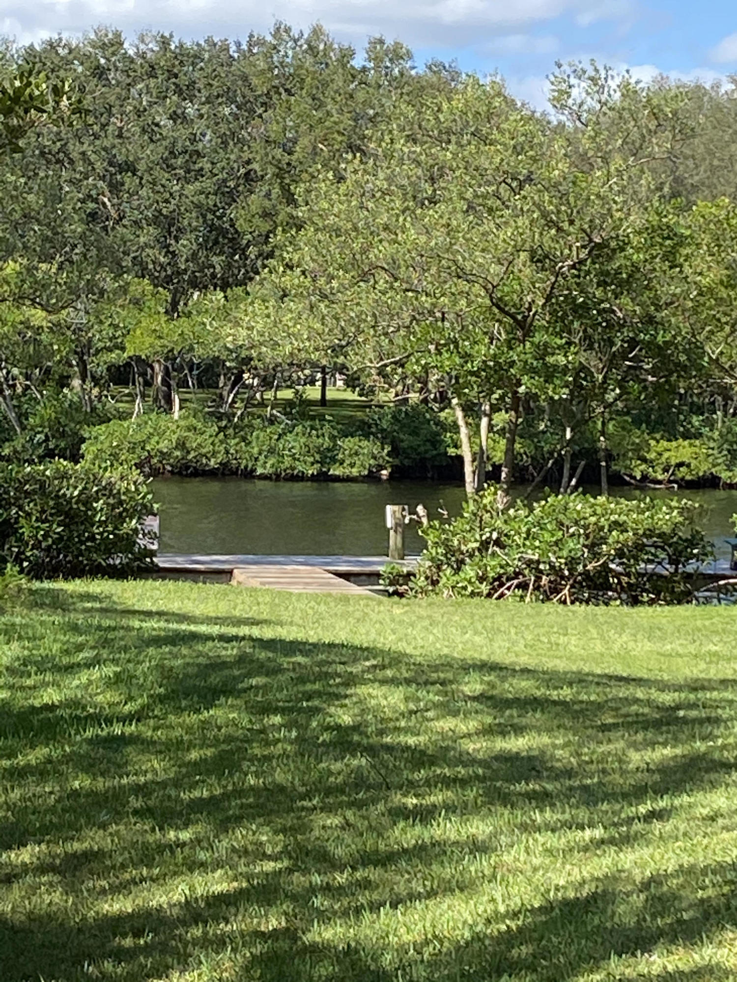 6183 Riverwalk Lane, Unit 3 Jupiter, FL 33458 - Photo 15 of 35 a view of a golf course with a lake