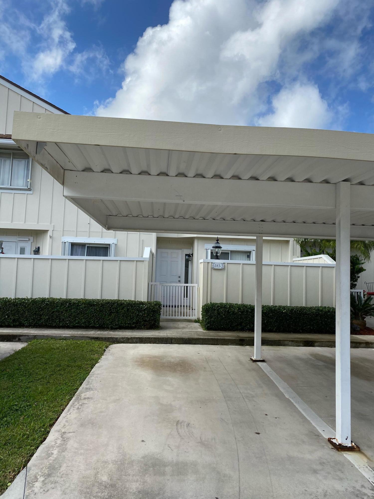 6183 Riverwalk Lane, Unit 3 Jupiter, FL 33458 - Photo 2 of 35 a view of a car garage