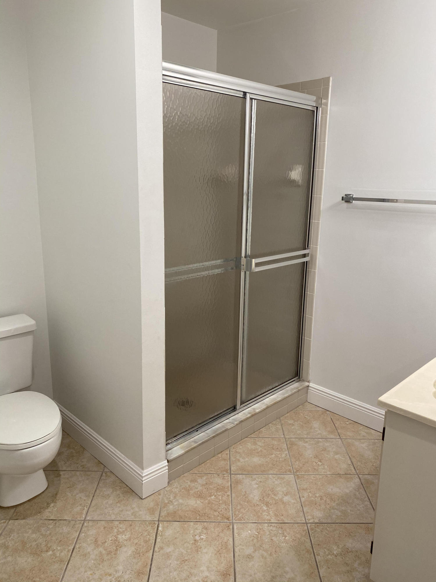 6183 Riverwalk Lane, Unit 3 Jupiter, FL 33458 - Photo 21 of 35 a bathroom with a granite countertop toilet and a glass door