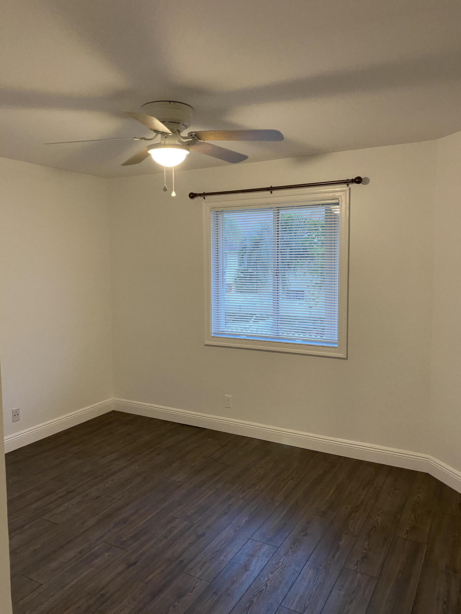 6183 Riverwalk Lane, Unit 3 Jupiter, FL 33458 - Photo 22 of 35 a view of an empty room with wooden floor and a window