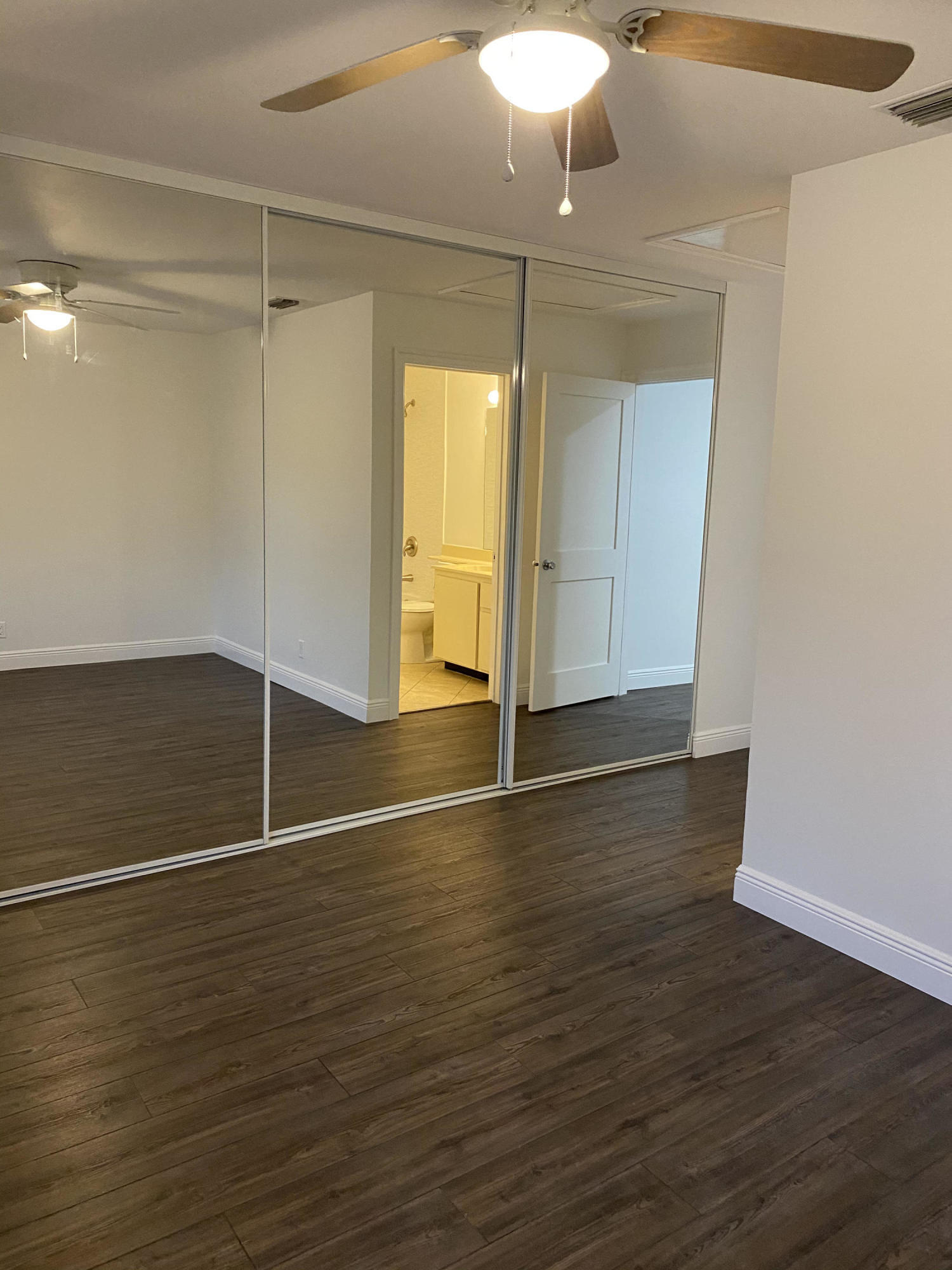 6183 Riverwalk Lane, Unit 3 Jupiter, FL 33458 - Photo 23 of 35 a view of an empty room with wooden floor