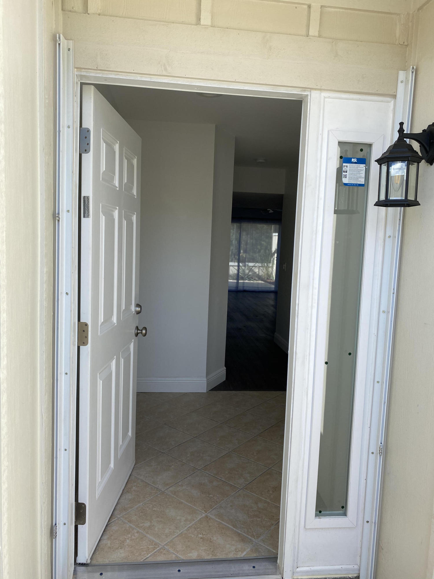 6183 Riverwalk Lane, Unit 3 Jupiter, FL 33458 - Photo 5 of 35 a view of a hallway with wooden floor and entryway