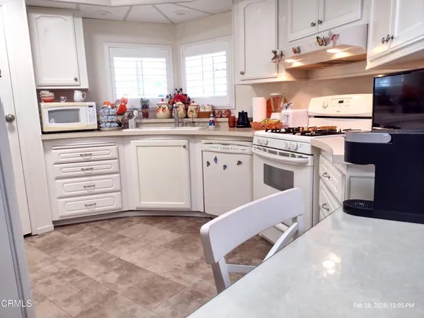 a kitchen with cabinets appliances and a window