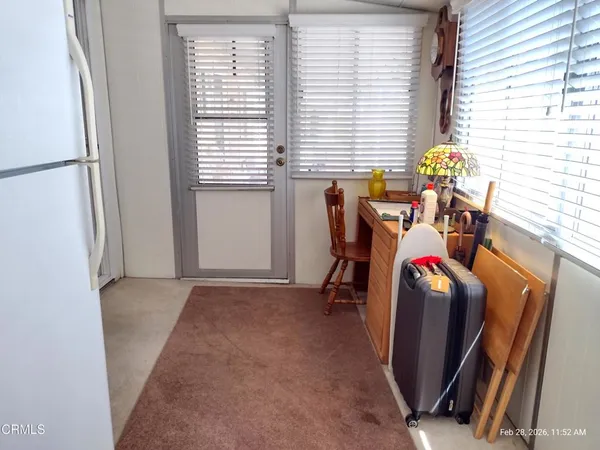 a living room with a bed furniture and a window