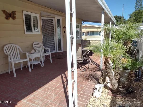 a view of a patio with table and chairs and potted plants