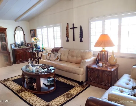 a living room with furniture a rug and a large window
