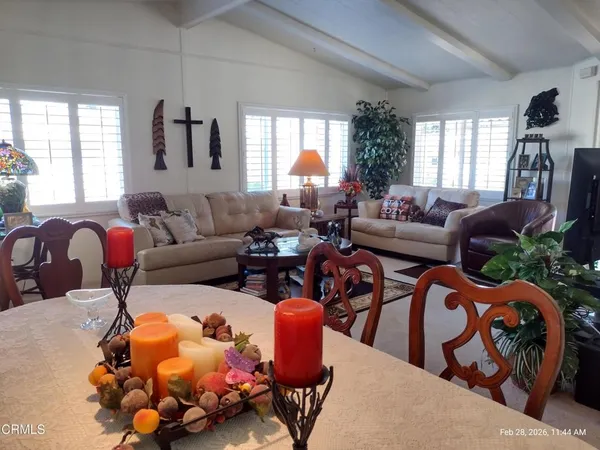 a living room with furniture a window and a wooden floor