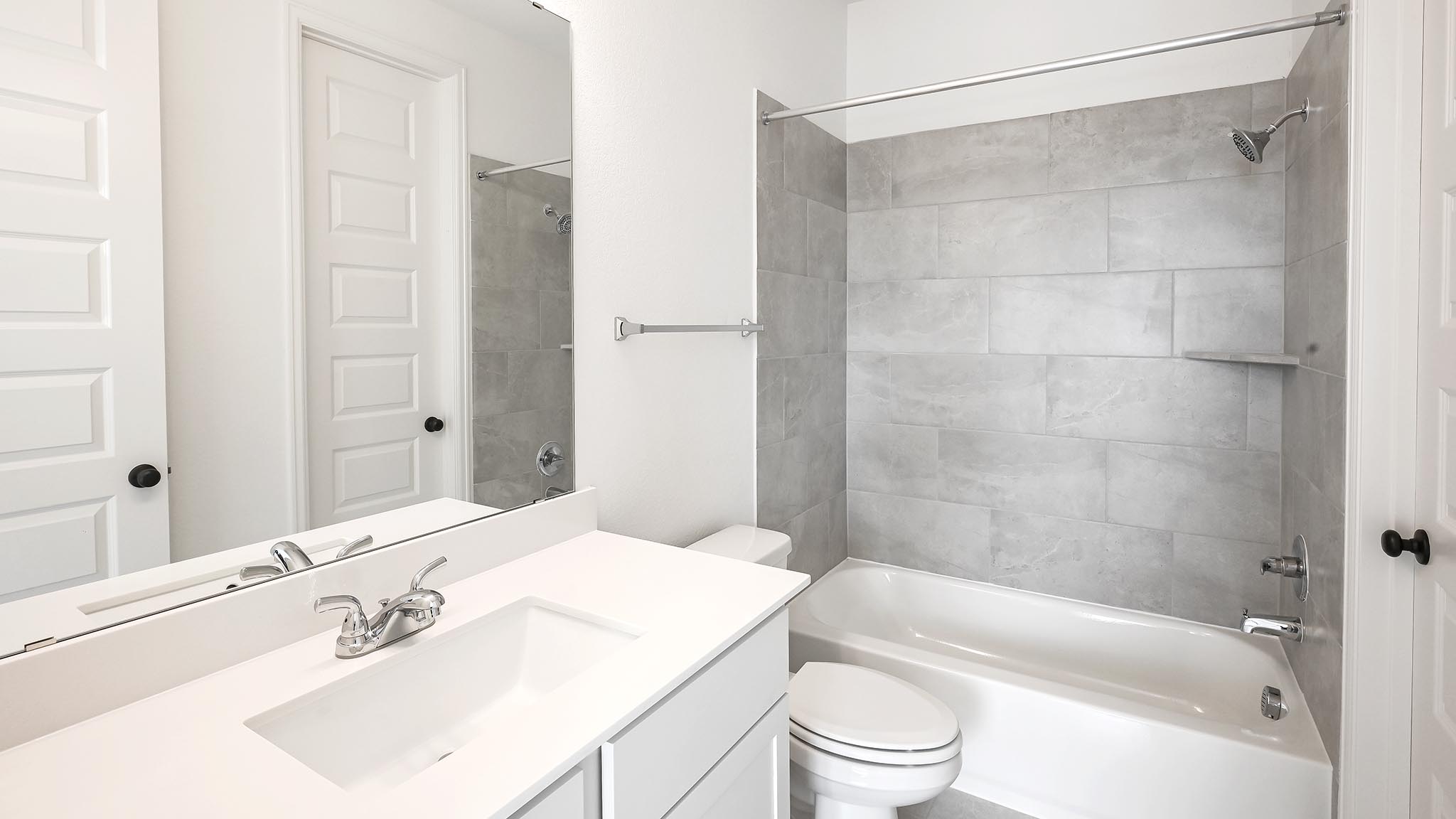 3921 Melody Road Lockhart, TX 78644 - Photo 18 of 30 a bathroom with a bathtub shower sink vanity and toilet