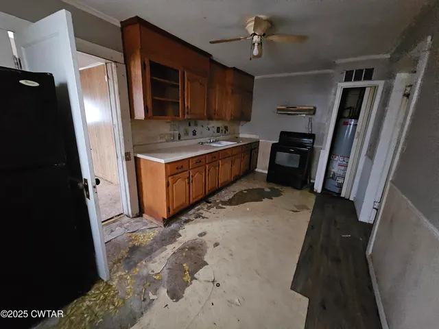 a kitchen with sink refrigerator and microwave