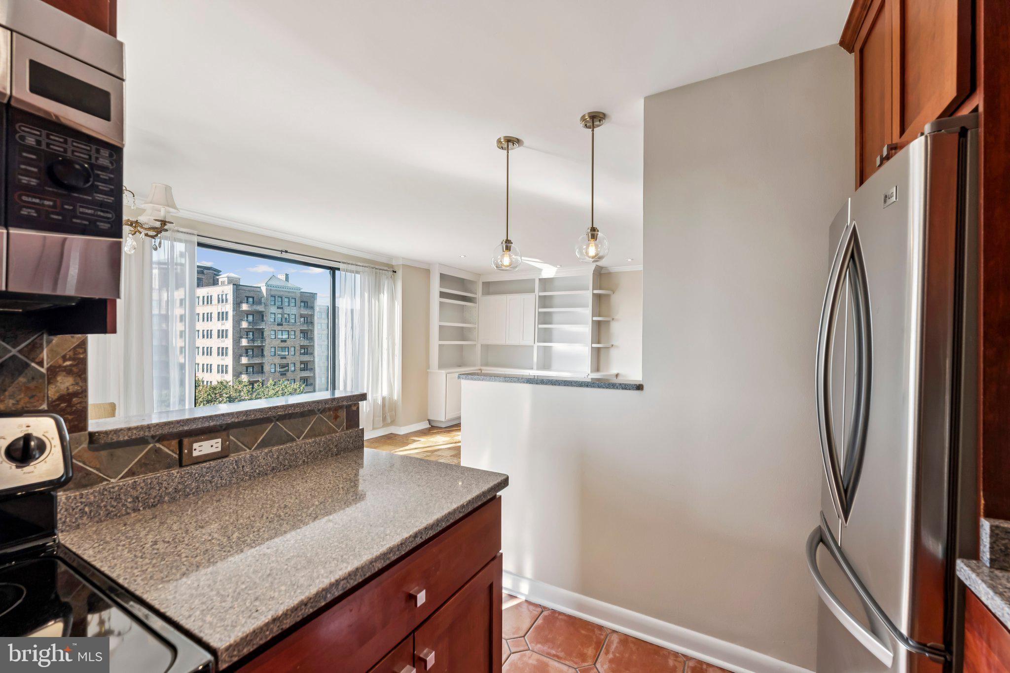 2501 Calvert Street Northwest, Unit 701 Washington, DC 20008 - Photo 13 of 29 a view of a kitchen with stainless steel appliances granite countertop a refrigerator and a sink
