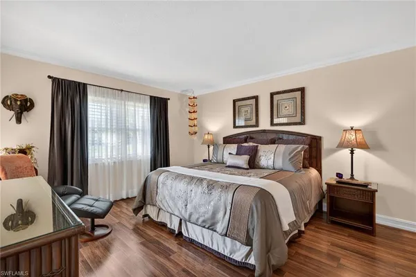 a bedroom with furniture and a flat screen tv