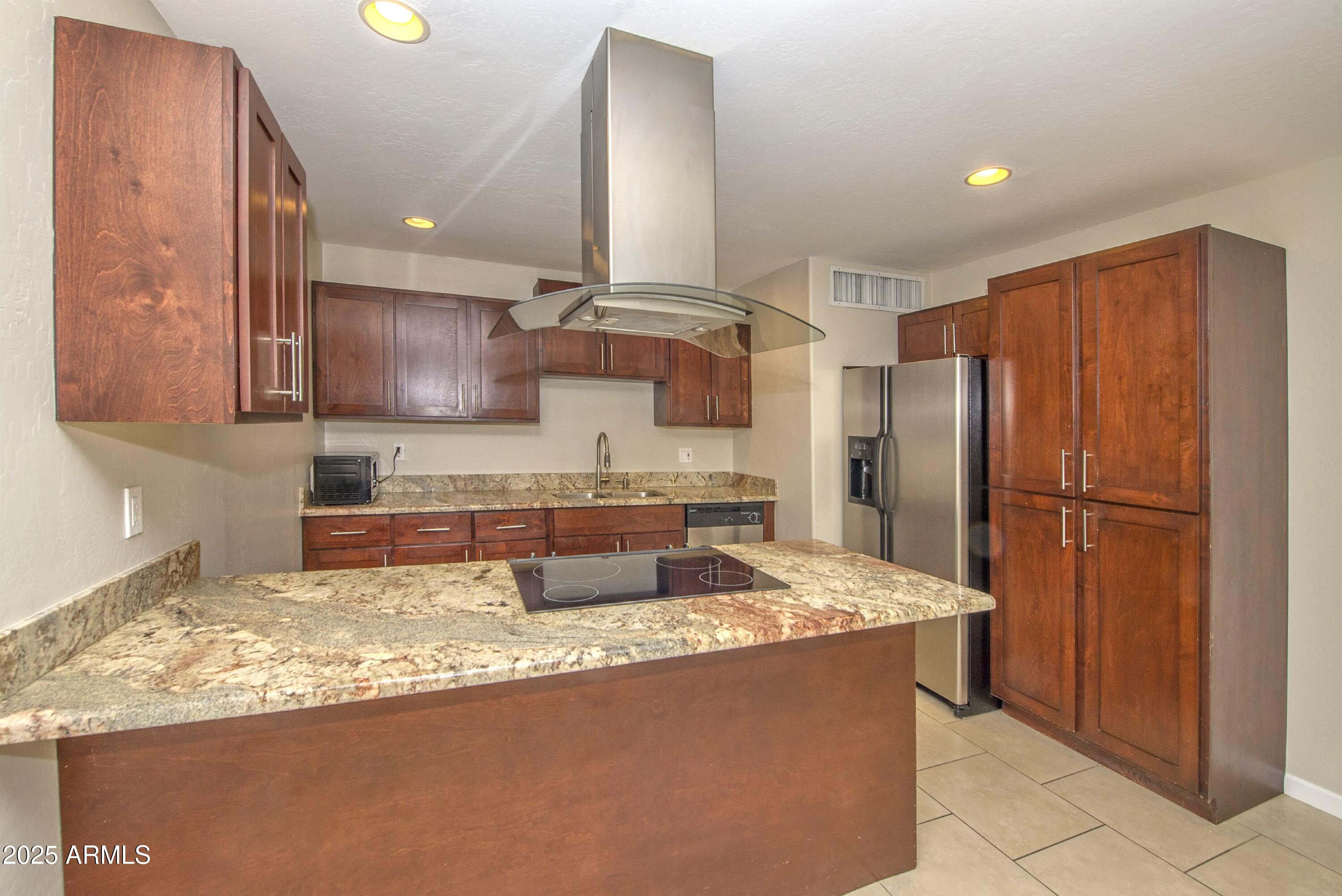36 East Fillmore Street Tempe, AZ 85288 - Photo 5 of 15 a kitchen with stainless steel appliances granite countertop a refrigerator a stove and a sink