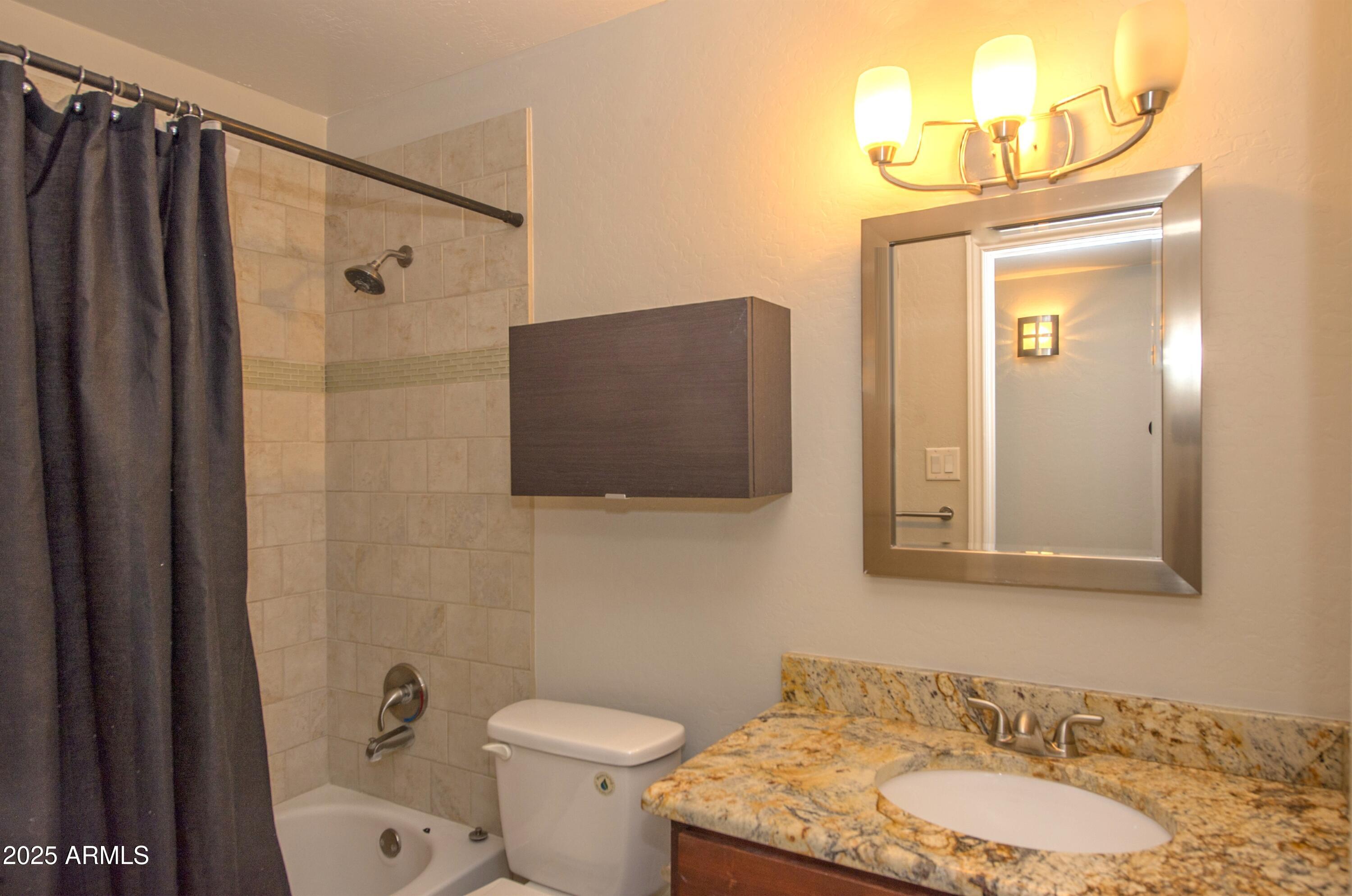 36 East Fillmore Street Tempe, AZ 85288 - Photo 7 of 15 a bathroom with a granite countertop sink toilet and shower