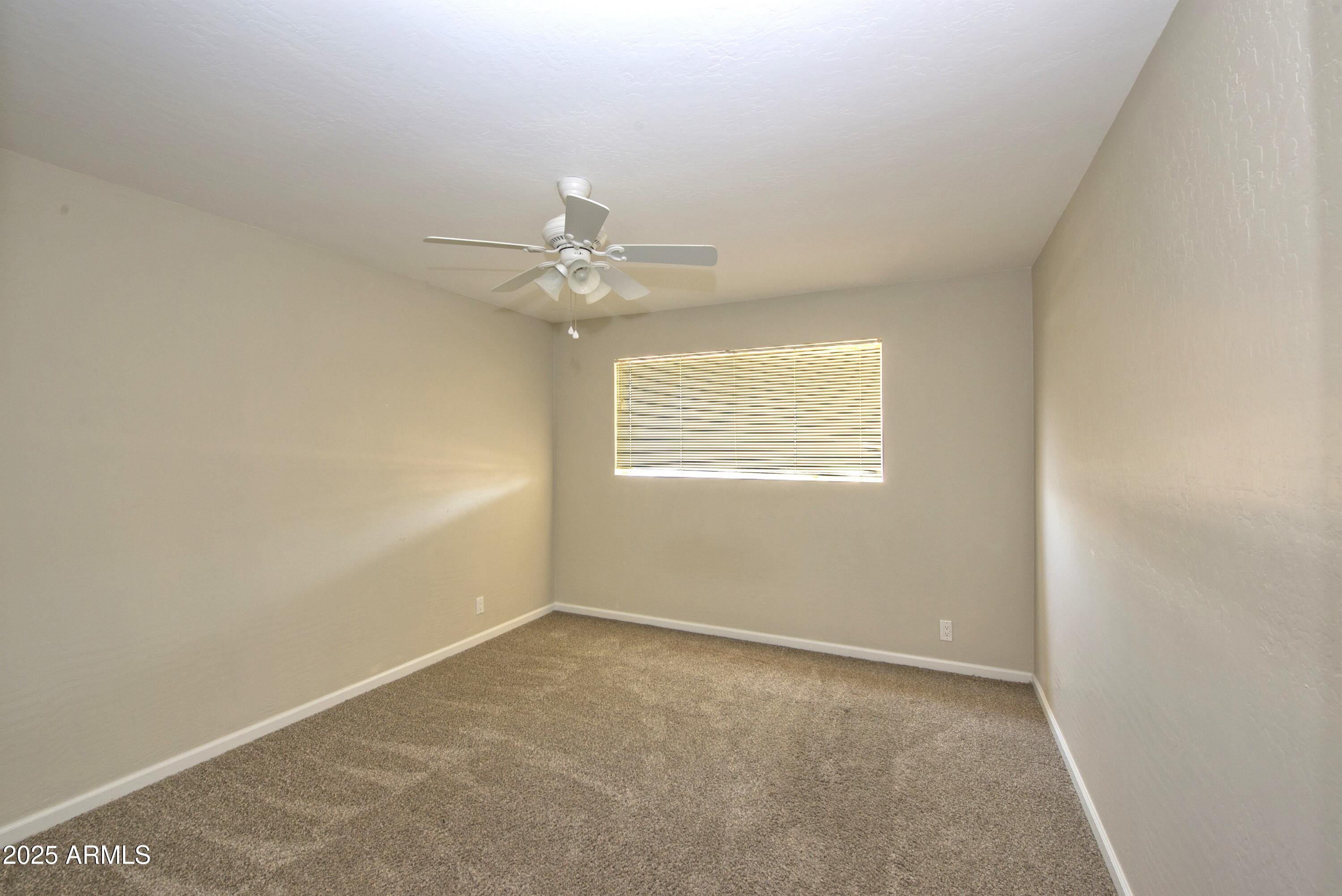 36 East Fillmore Street Tempe, AZ 85288 - Photo 8 of 15 an empty room with windows and fan